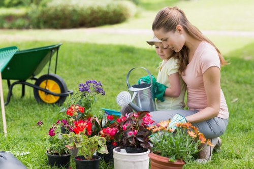 Gardener with mower on a residential lawn
